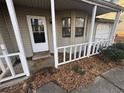 Home's entrance with white railings and a view of the front yard at 5451 Zachary Dr, Stone Mountain, GA 30083