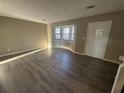 Living room with hardwood floors, bay window, and neutral walls at 5451 Zachary Dr, Stone Mountain, GA 30083