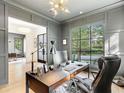 Modern home office with wood desk and gray paneled walls at 595 Sherwood Ne Rd, Atlanta, GA 30324