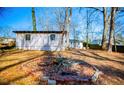 Large backyard with fire pit and mature trees at 1991 Judy Se Cir, Marietta, GA 30060