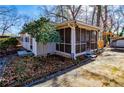 Relaxing screened porch with wooden swing and yard access at 1991 Judy Se Cir, Marietta, GA 30060