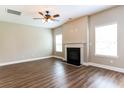 Spacious living room featuring hardwood floors and a fireplace at 4001 Village Crossing Cir, Ellenwood, GA 30294