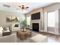 Living room with fireplace, hardwood floors, and stylish furniture at 4001 Village Crossing Cir, Ellenwood, GA 30294