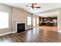 Open-concept living room with hardwood floors and kitchen view at 4001 Village Crossing Cir, Ellenwood, GA 30294