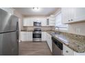 Modern kitchen with granite countertops and stainless steel appliances at 491 Elbridge Nw Dr, Atlanta, GA 30318