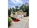 Two-car garage with concrete driveway and landscaping at 2842 Cardinal Lake Dr, Duluth, GA 30096