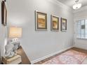 Bright entryway with hardwood floors and modern wall art at 1182 Chastain Dr # 8, Sugar Hill, GA 30518