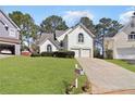 Beautiful suburban home with manicured lawn, a two-car garage and an inviting driveway, showcasing classic charm at 3812 Chalmers Ct, Clarkston, GA 30021