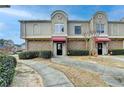 Two-story townhome with red awning and manicured landscaping at 3301 Henderson Mill Rd # R1, Chamblee, GA 30341