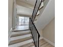 Modern staircase with black metal railing and light wood steps at 3301 Henderson Mill Rd # R1, Chamblee, GA 30341