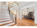 Grand two-story foyer with elegant staircase and views to dining room at 4720 Cliffside Ct, Marietta, GA 30067