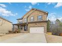 Two-story brick home with attached garage and landscaped lawn at 654 Ocean Ave, Canton, GA 30114