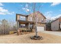 Two-story brick home with attached garage and landscaped lawn at 654 Ocean Ave, Canton, GA 30114