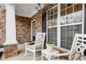 Inviting front porch with rocking chairs, stonework, and a charming planter at 315 Ridgewood Trl, Canton, GA 30115