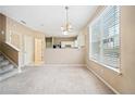 Bright dining room features a chandelier and kitchen views at 6691 Sunset Hills Blvd, Rex, GA 30273