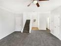 Bright living room featuring gray carpeting and a staircase at 1535 Valley Club Dr, Lawrenceville, GA 30044