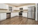 Modern kitchen with stainless steel appliances and wood-look flooring at 4074 Yeager Rd, Douglasville, GA 30135