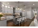 Modern kitchen with white cabinets, granite counters and island at 1102 Fountain Sw Dr, Atlanta, GA 30314