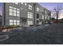 Townhome complex with parking and modern design at dusk at 85 Boulevard Ne, Atlanta, GA 30312