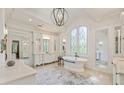 Luxurious bathroom with soaking tub, marble countertops, and custom cabinetry at 4874 Kettle River Pt, Suwanee, GA 30024