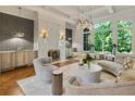 Spacious living room with a fireplace, large windows and curved seating at 4874 Kettle River Pt, Suwanee, GA 30024