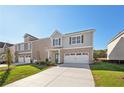 Two-story home with gray siding, brick accents, and a two-car garage at 11827 Rizvan Pl, Covington, GA 30014