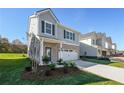 Two-story home with gray siding, brick accents, and a two-car garage at 11827 Rizvan Pl, Covington, GA 30014