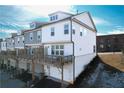 Rear view of townhome showing a deck, garage, and additional outdoor space at 2709 Richmond Row Dr, Suwanee, GA 30024