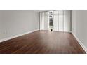 Large living room with hardwood floors and floor to ceiling windows at 2479 Peachtree Rd # 101, Atlanta, GA 30324