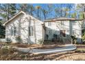 Two story house exterior, featuring a light colored stucco exterior, walkway and landscaping at 4147 Azalea Ct, Snellville, GA 30039