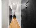 Apartment entry hallway with hardwood floors and black door at 800 Peachtree Ne St # 8607, Atlanta, GA 30308