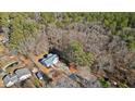 Aerial view showing house location and wooded surroundings at 304 Stations Ave, Woodstock, GA 30189