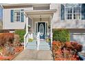 Inviting front porch with seating and landscaping at 304 Stations Ave, Woodstock, GA 30189