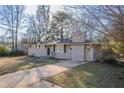 Ranch style home features a stone fireplace and a large driveway at 3854 Brookcrest Cir, Decatur, GA 30032