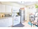 White kitchen with stainless steel appliances and granite countertops at 6034 Regent Mnr, Lithonia, GA 30058