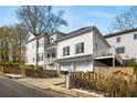 Two-story white house with a detached garage, deck, and fenced yard at 1399 Knob Hill Se Ct, Atlanta, GA 30316