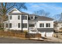 Well-maintained two-story white house with black shutters, featuring a two-car garage and private side balcony at 1399 Knob Hill Se Ct, Atlanta, GA 30316