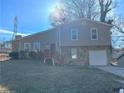 Two-story house with stone accents, attached garage, and a wooden deck at 3690 Darrah Sw Way, Atlanta, GA 30331