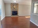 Living room with hardwood floors, stone fireplace, and ceiling fan at 3690 Darrah Sw Way, Atlanta, GA 30331