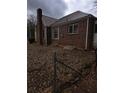 Brick house with metal roof and leaf covered yard at 1643 Westhaven Sw Dr, Atlanta, GA 30311