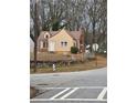 Tan and brick house with metal roof and stone wall at 1643 Westhaven Sw Dr, Atlanta, GA 30311