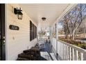 Covered porch with rocking chairs and wood storage at 51 Willow Bend Nw Dr, Cartersville, GA 30121