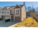 Two-story townhouse with a two-car garage and small yard at 5531 Pine Aly, Lithonia, GA 30058