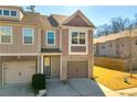 Townhouse with 2-car garage, brick and siding exterior at 5531 Pine Aly, Lithonia, GA 30058