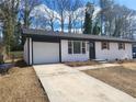 Updated ranch home with white brick exterior, new roof and driveway at 4664 Ryan Rd, Conley, GA 30288