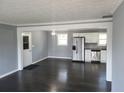 Open concept kitchen with stainless steel appliances and dark hardwood floors at 4664 Ryan Rd, Conley, GA 30288