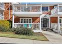 Charming brick building with white trim, balcony and porch with walkway to black-framed glass entry door at 885 Briarcliff Ne Rd # 21, Atlanta, GA 30306
