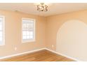 Bedroom with light walls, hardwood floors, and an accent wall at 39 Lake Dr, Bowdon, GA 30108