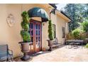 Inviting stone patio with a charming entrance, lush greenery, and wrought iron accents at 23 Paces West, Atlanta, GA 30327