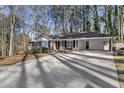 Long driveway leading to a brick ranch house with covered carport at 3251 Wanda Woods Dr, Atlanta, GA 30340